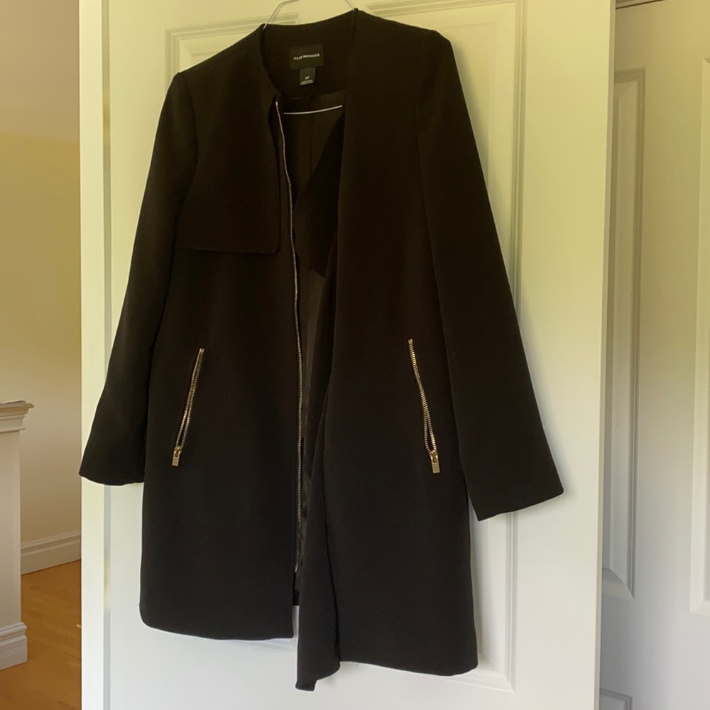 Fall/Winter women’s black zip coat with ruffled treatment on left lapel